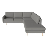 Modern gray sectional sofa with sleek lines and a minimalist design, featuring light wooden legs.