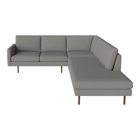 "Modern gray sectional sofa with a sleek design and soft fabric upholstery, featuring minimalist lines and wooden legs."