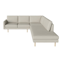 Light beige sectional sofa with smooth fabric and minimalist design, featuring wooden legs and clean lines.