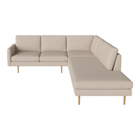 Beige sectional sofa with smooth upholstery and minimalist design, featuring light wooden legs.