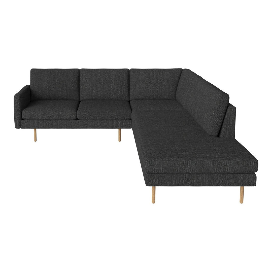 Modern black sectional sofa with clean lines and a textured fabric pattern, featuring light wooden legs.