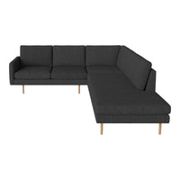 Modern black sectional sofa with clean lines and a textured fabric pattern, featuring light wooden legs.