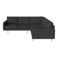 Modern L-shaped sofa in dark grey fabric with clean lines and tapered wooden legs, perfect for contemporary spaces.