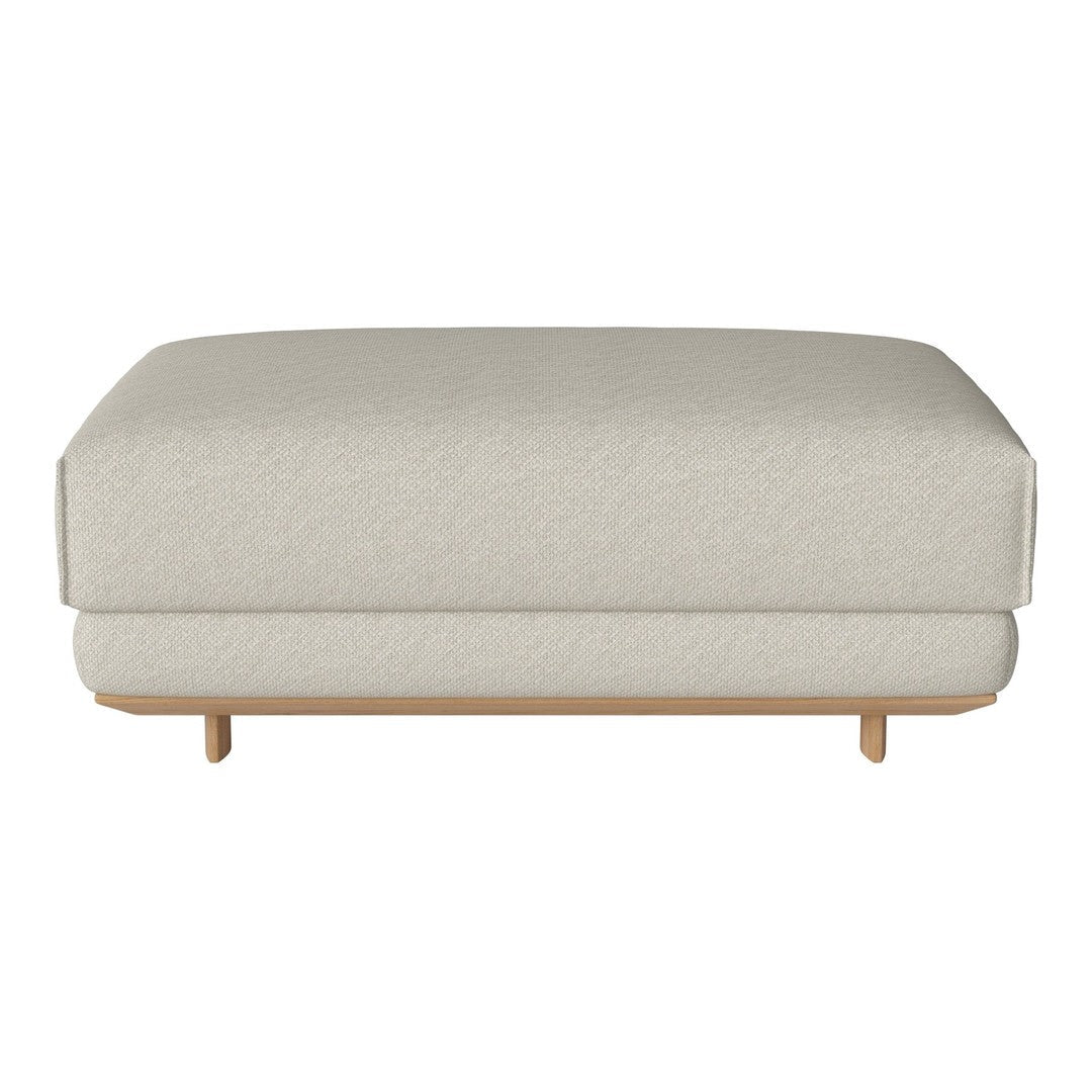 Neutral beige ottoman with a subtle woven texture and natural wooden legs, perfect for versatile decor styles.