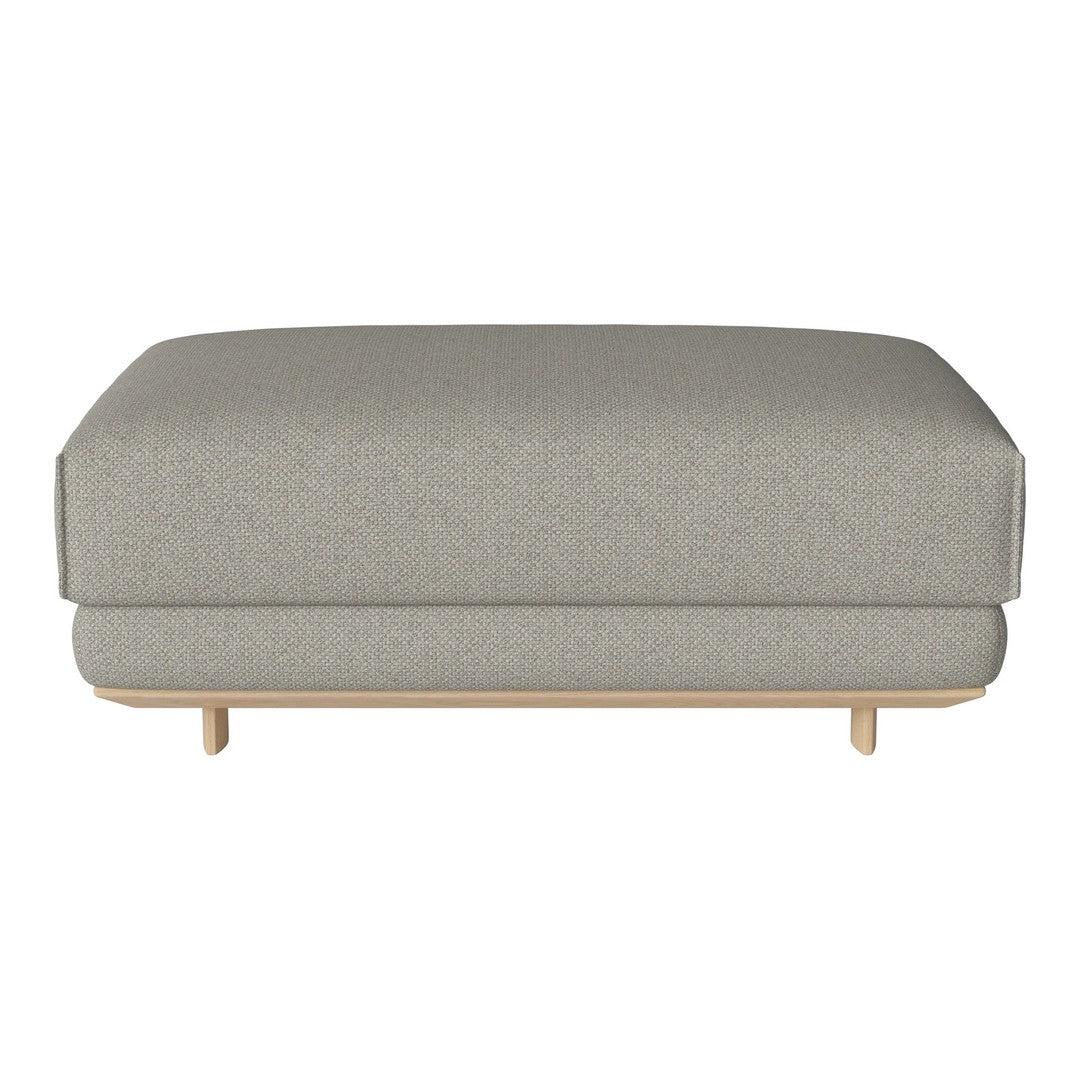 Gray upholstered ottoman with a smooth texture and minimalist design, featuring natural wood legs for a contemporary look.