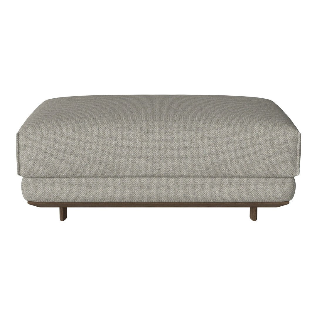 Light gray upholstered ottoman with subtle textures and clean lines, featuring a natural wood base.