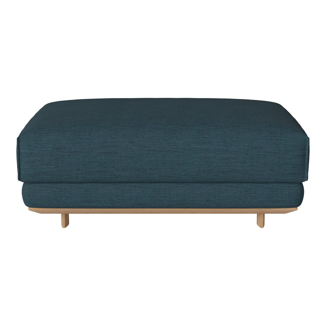 Teal upholstered ottoman with a smooth texture and minimalist design, featuring a natural wood base.