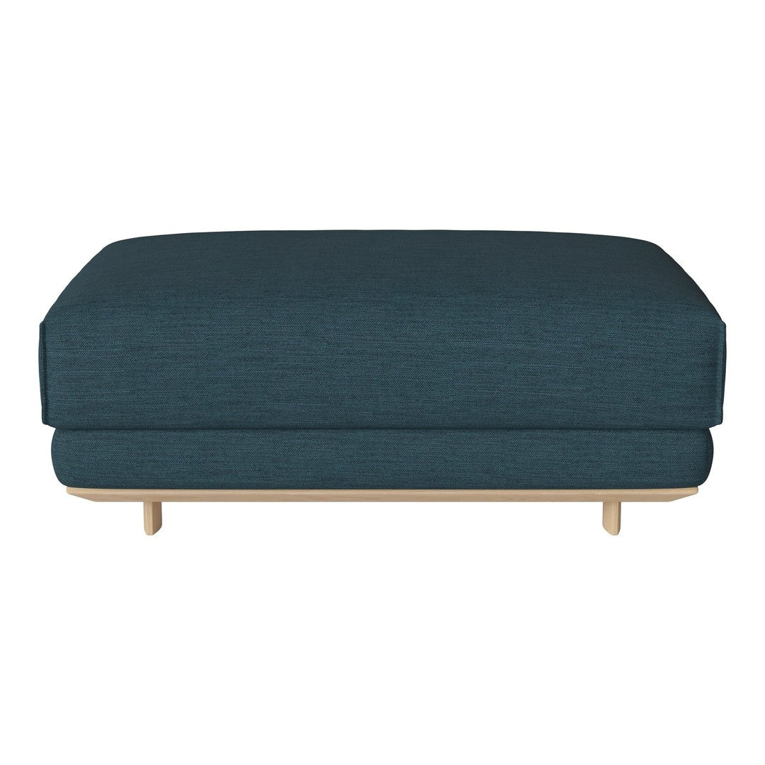 Teal upholstered ottoman with a simple, modern design and light wood legs, adding a pop of color to any space.