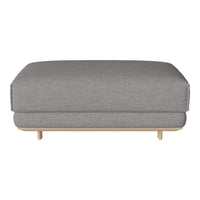 Gray upholstered ottoman with a textured fabric and natural wood legs. Modern, minimalist design for versatile decor.