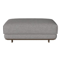 Gray upholstered ottoman with a clean, minimalist design and subtle texture, featuring a sleek wooden base.