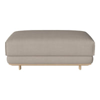 Beige upholstered ottoman with a smooth, solid pattern and light wooden legs, ideal for modern decor.