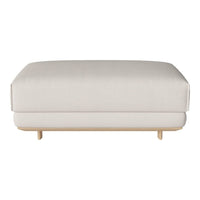 Light beige upholstered ottoman with a smooth, minimalist design and natural wood legs.