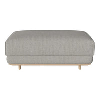 Light grey upholstered ottoman with a subtle textured pattern and natural wood legs. Stylish and modern design.