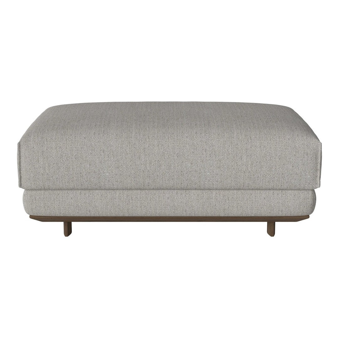 Light gray upholstered ottoman with a subtle textured pattern and wooden base. Modern and versatile design for any space.