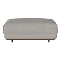 Light gray upholstered ottoman with a subtle textured pattern and wooden base. Modern and versatile design for any space.