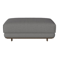 Gray upholstered ottoman with a textured pattern and wooden legs, perfect for modern living spaces.