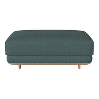 Teal upholstered ottoman with a subtle textured pattern and light wood legs, perfect for modern decor.