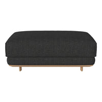 Textured dark gray ottoman with a sleek design and natural wood legs in a minimalist style. Perfect for modern interiors.
