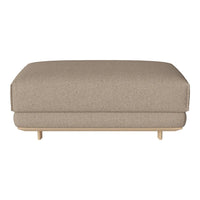 Beige upholstered ottoman with a smooth, minimalist design and light wooden legs. Ideal for modern interiors.