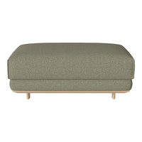 Olive green upholstered ottoman with a subtle textured pattern and light wood legs, perfect for modern decor.
