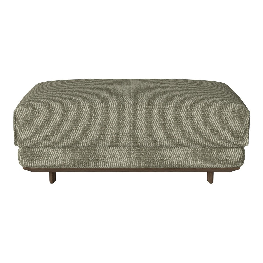 Green textured ottoman with a subtle pattern and wooden legs, perfect for modern home decor.