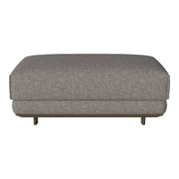 Gray upholstered ottoman with a textured fabric and solid wood base, perfect for modern living spaces.