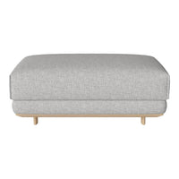 Grey fabric ottoman with a smooth texture and light wood legs, perfect for modern interior decor.