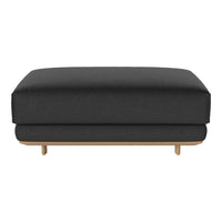 Black upholstered ottoman with a smooth surface and light wood legs, minimalistic design and modern style.
