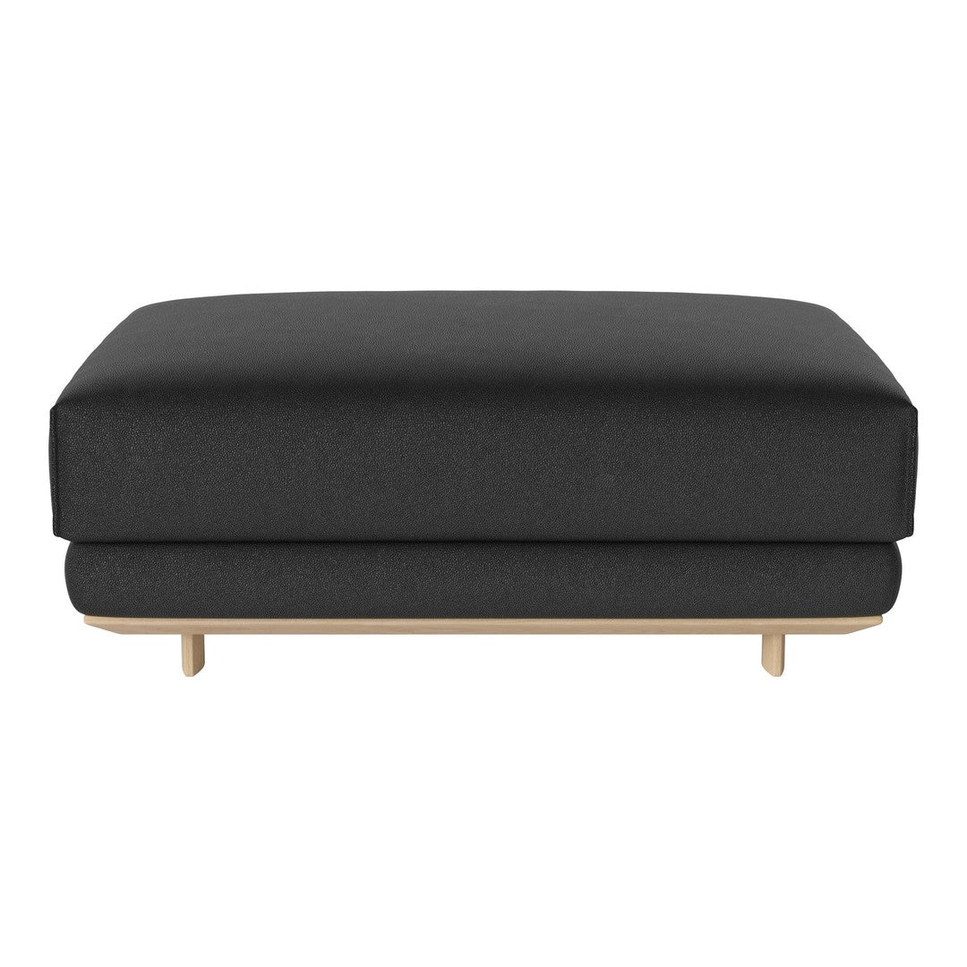 Black upholstered ottoman with a smooth texture and natural wood base. Minimalist design for modern interiors.