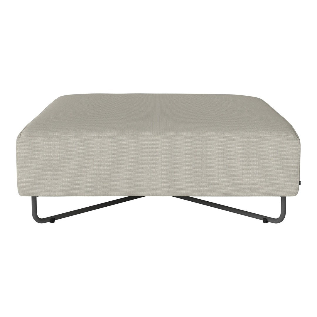 Light beige ottoman with a smooth fabric texture and sleek black metal legs. Modern design for versatile decor.