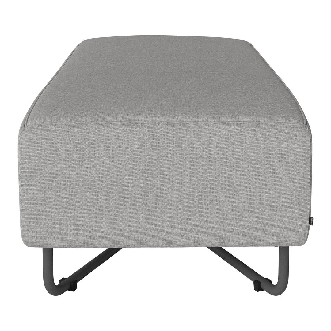 Gray upholstered ottoman with clean lines and a minimalist design on a sleek black metal base.