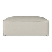 Neutral beige ottoman with a soft textured fabric pattern, perfect for modern home decor.