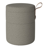 Round gray storage ottoman with a textured pattern and a leather pull handle. Perfect for stylish organization.