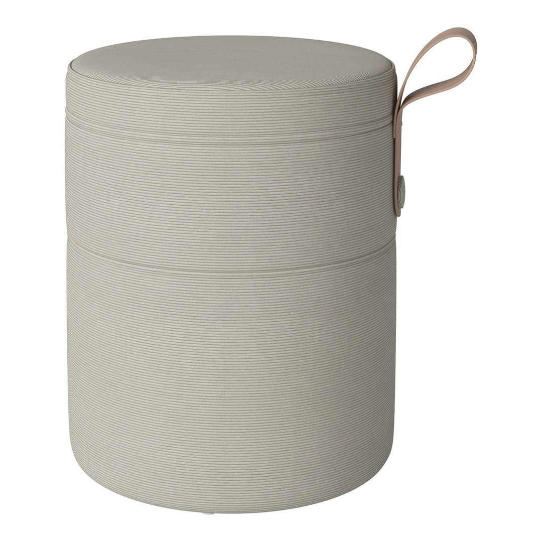 Light grey cylindrical storage ottoman with smooth fabric texture and tan leather handle. Modern minimalist design.