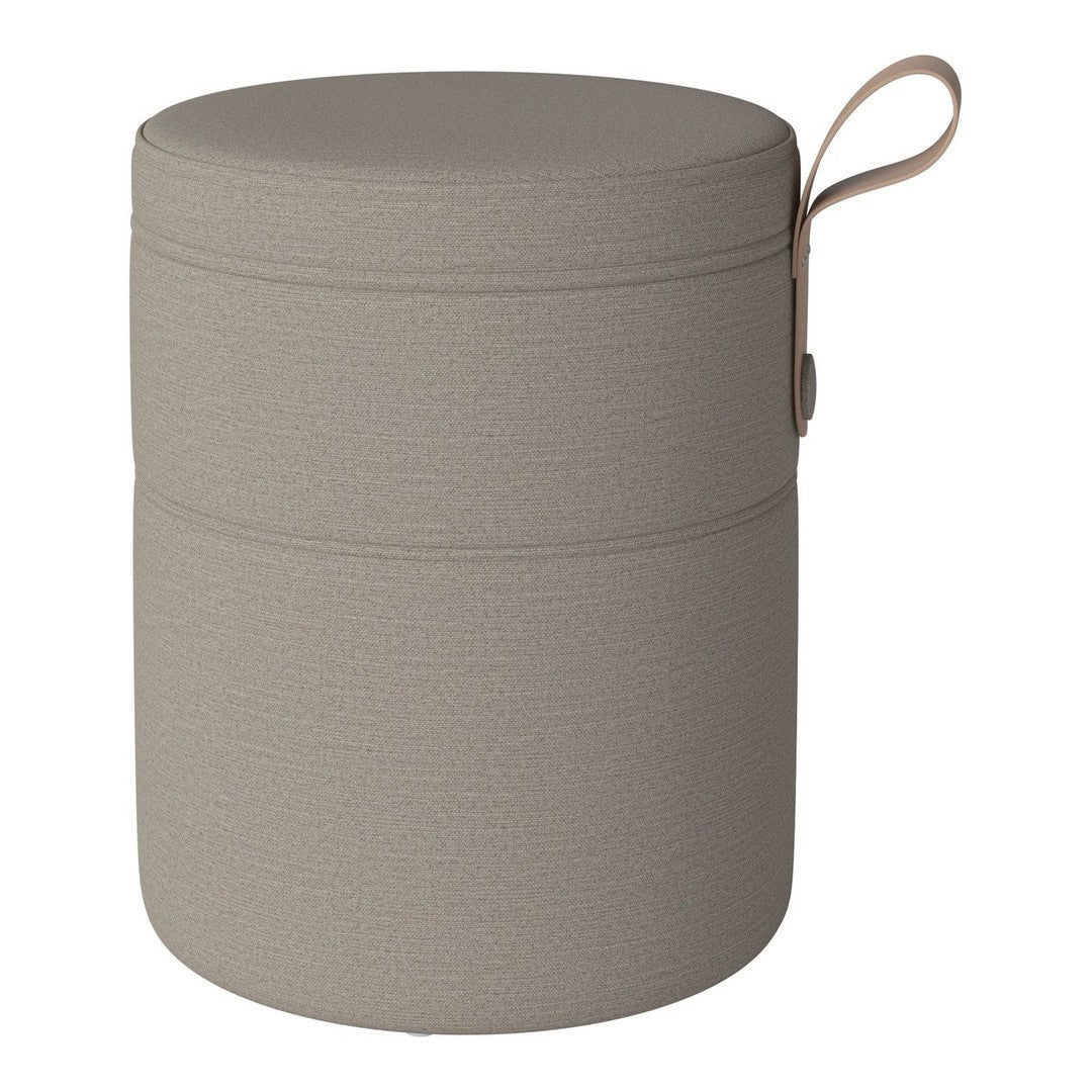 Neutral beige storage ottoman with textured pattern and a matching handle for easy transport.