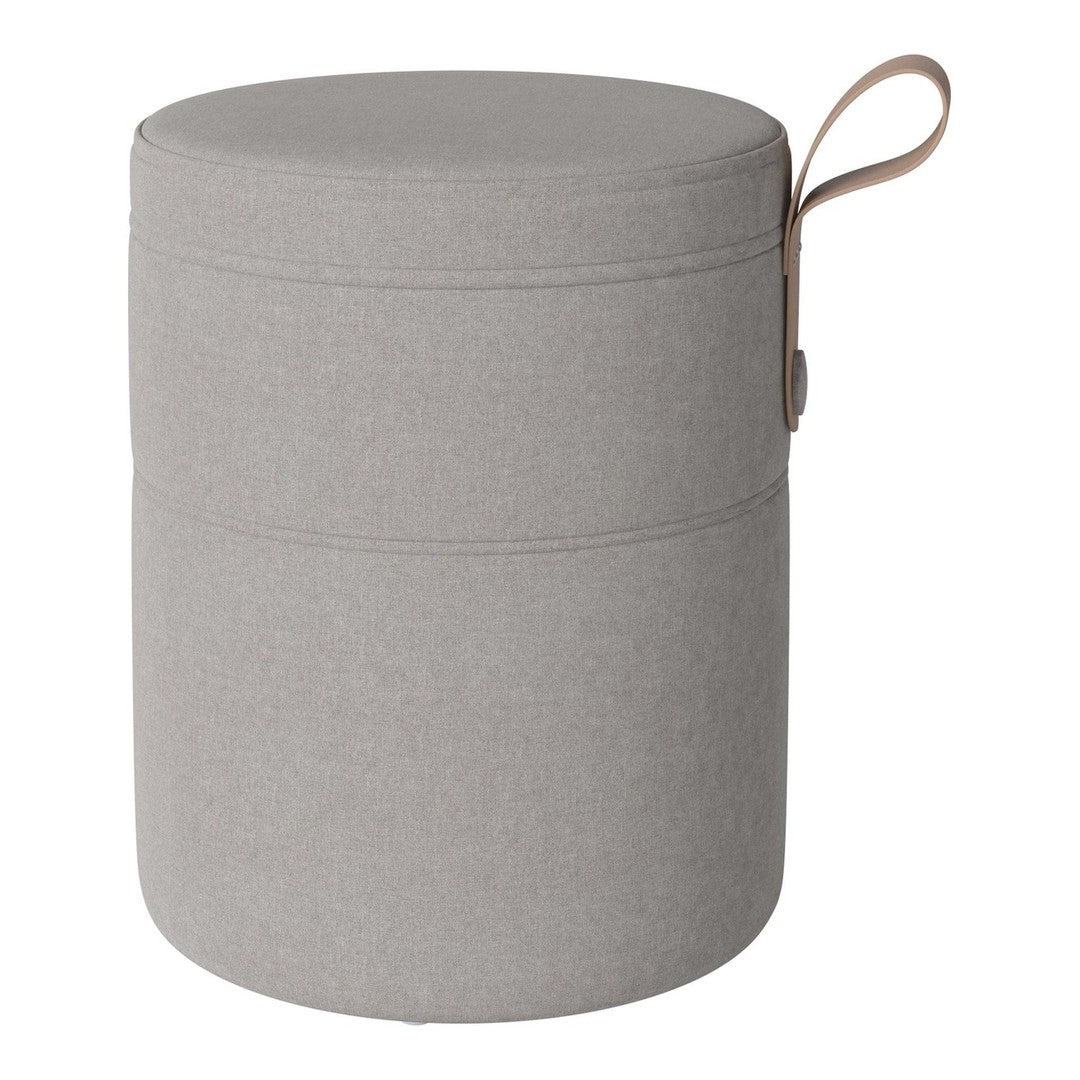 Grey fabric storage ottoman with a round shape and a top handle for easy mobility. Simple, modern design.