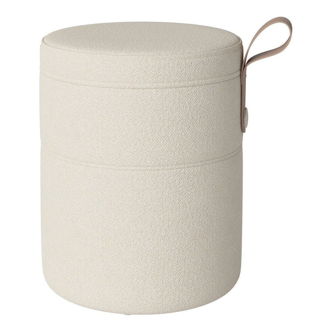 Cream textured round storage ottoman with a minimalistic design and a light brown handle.
