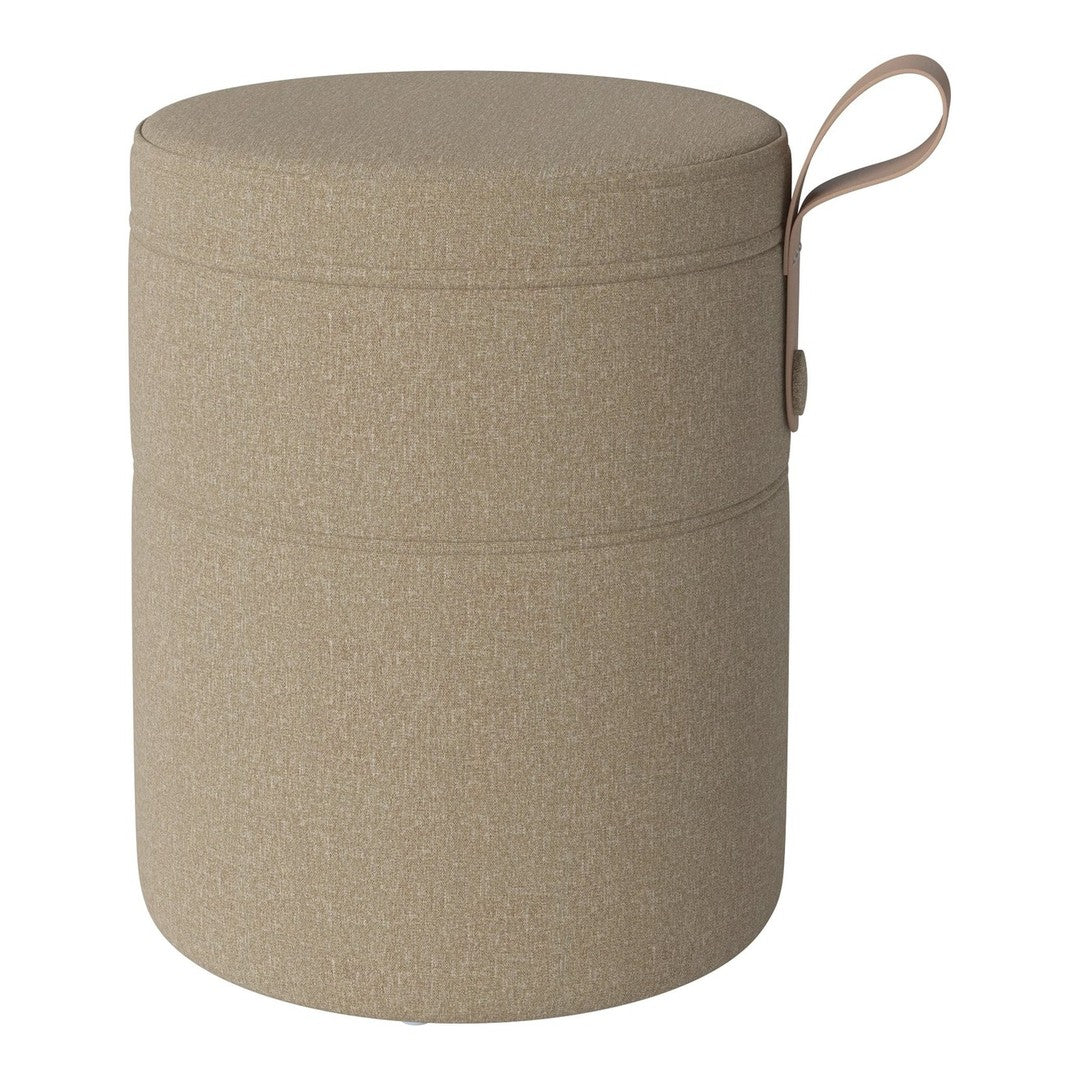 Beige fabric storage ottoman with a smooth texture and subtle sparkle, featuring a decorative handle.