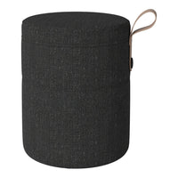 Round black storage ottoman featuring a textured fabric pattern with a tan leather handle.