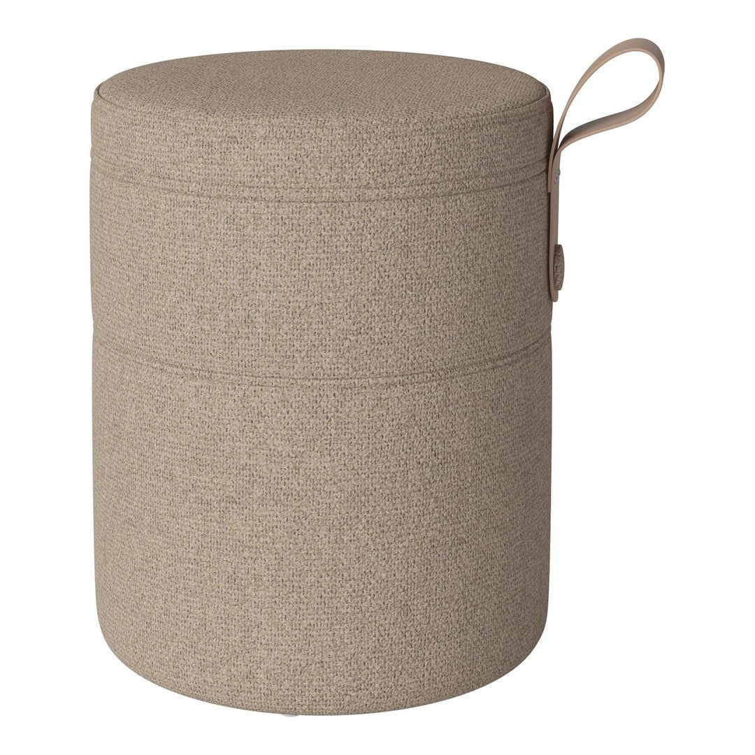 Round, textured storage ottoman in a warm beige hue with a seamless design and practical side handle.
