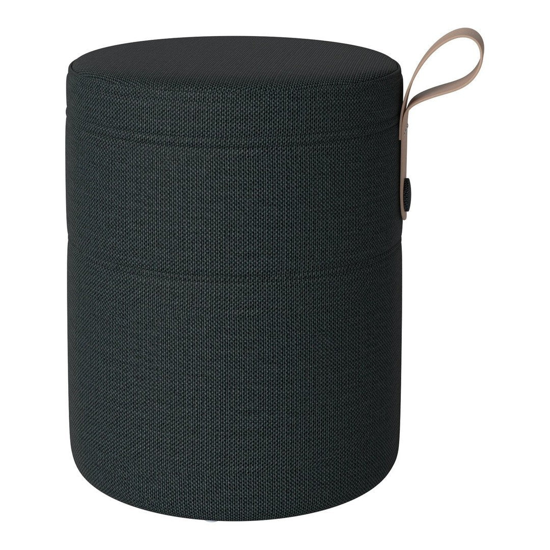 Dark green round storage stool with a textured pattern and a tan leather handle.