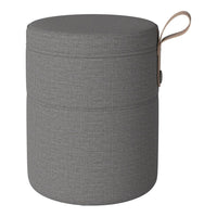 Gray round storage ottoman with a textured pattern and leather handle for easy carrying. Perfect for modern decor.