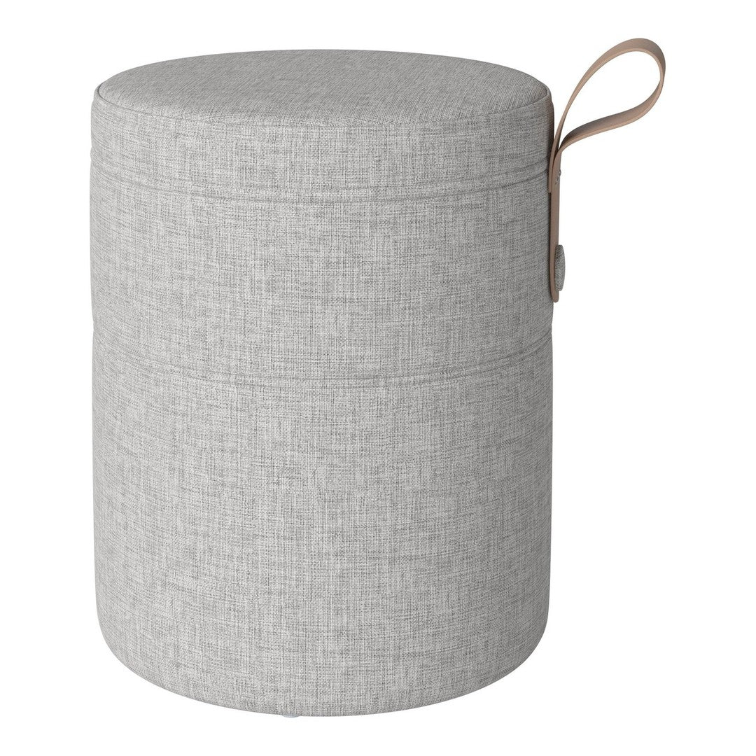 Gray fabric storage ottoman with a simple textured pattern and a tan handle. Ideal for modern interiors.