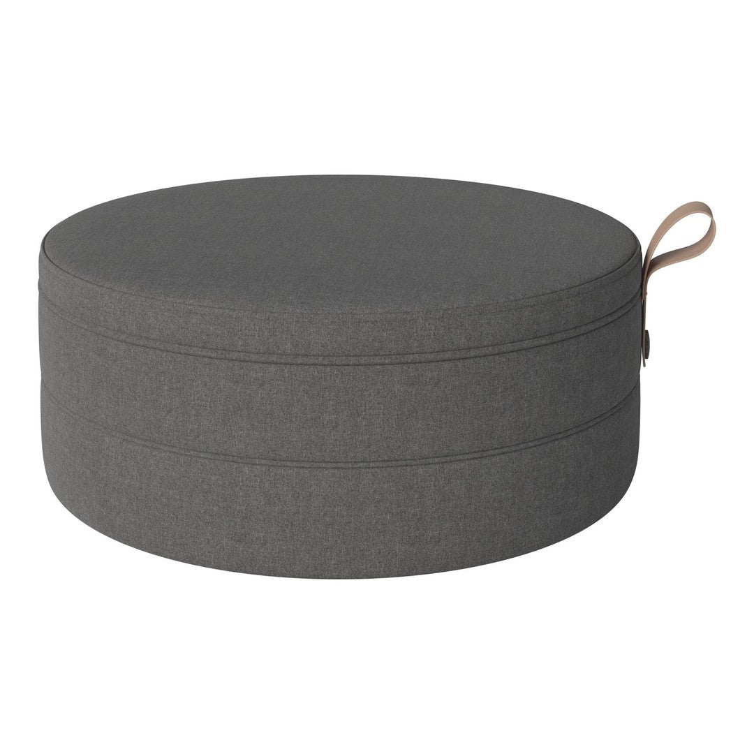 Round gray cushion with smooth fabric and subtle stitching detail, featuring a convenient side handle for easy transport.