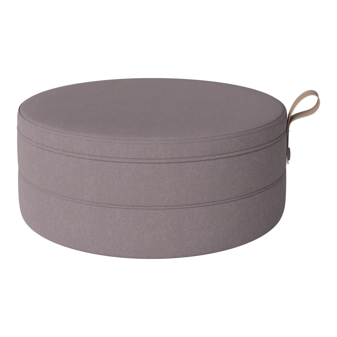 Round cushion in soft gray fabric with subtle texture and a decorative handle. Perfect for modern home decor.