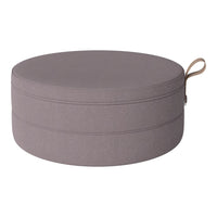 Round cushion in soft gray fabric with subtle texture and a decorative handle. Perfect for modern home decor.