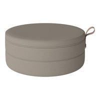 Round pouf in soft beige with a smooth, textured finish and subtle stitching detail. Ideal for modern decor.