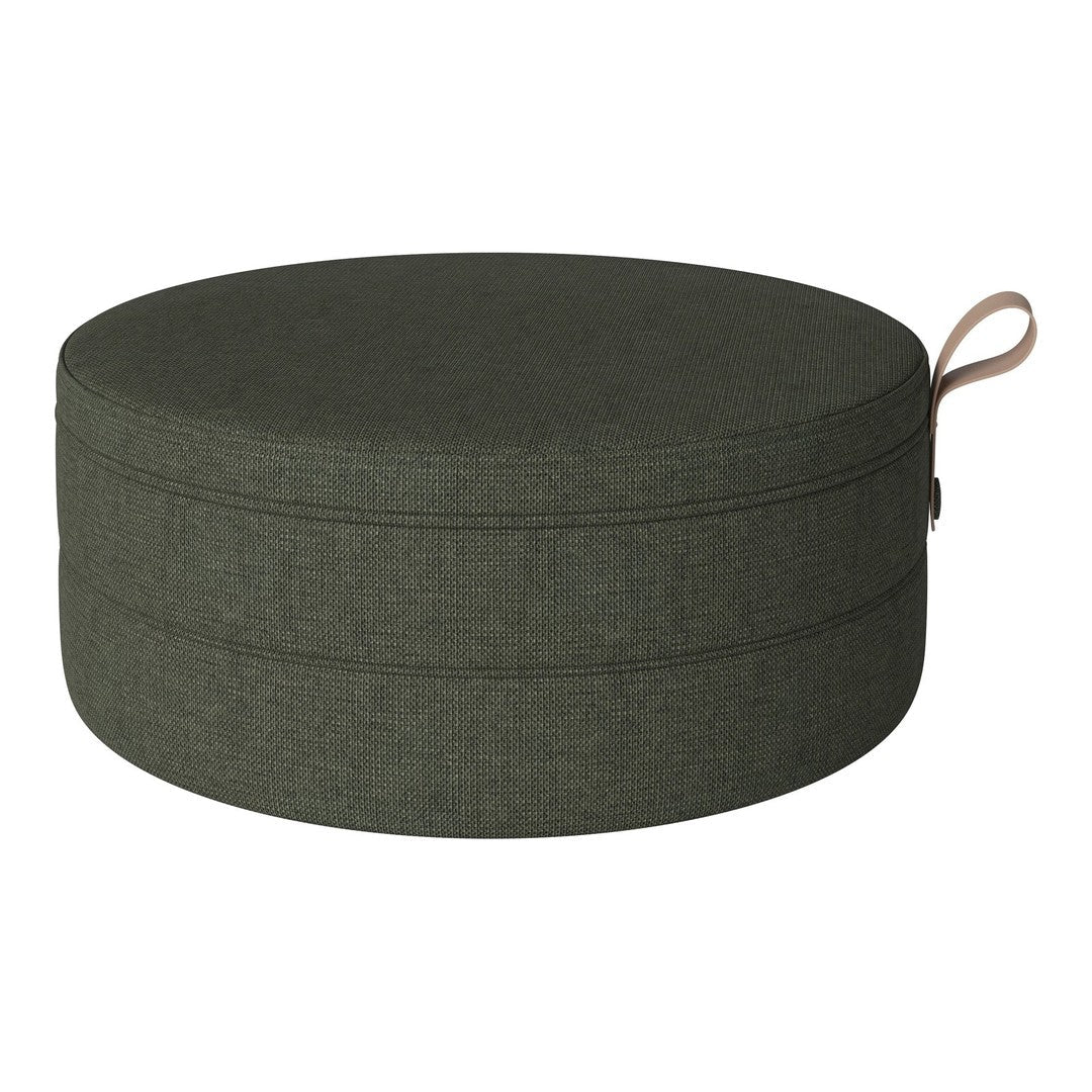 Round green fabric pouf with a textured pattern and a side handle. Ideal for modern decor.