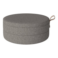 Gray, round storage ottoman with a textured fabric finish and a stylish tan handle, perfect for modern decor.