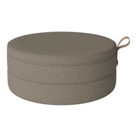 Round pet bed in a textured, muted taupe color with a simple woven pattern. Ideal for modern home decor.